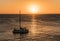 Group of unknown tourists on catamaran with lowered sails wait for Golden Sunset at crystal clear skies, CaribbeanÂ Sea, Jamaica